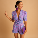 Women’s short summer jumpsuit with vibrant print, built-in belt, and flattering fit for warm days and casual events.