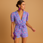 Women’s short summer jumpsuit with vibrant print, built-in belt, and flattering fit for warm days and casual events.
