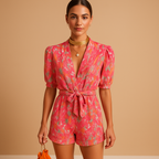 Women’s short summer jumpsuit with vibrant print, built-in belt, and flattering fit for warm days and casual events.