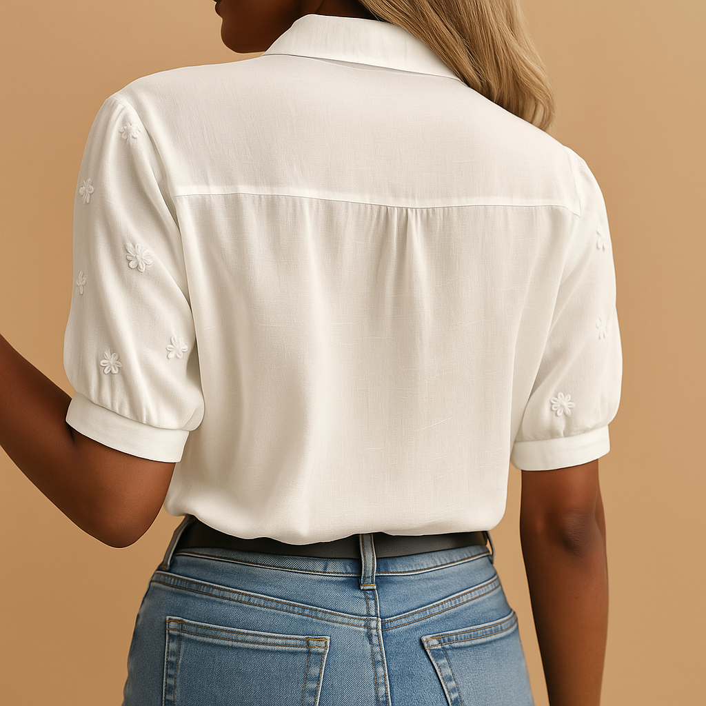 Women’s white blouse with tailored fit, classic collar, and button closure, perfect for work, casual days, or evening occasions.